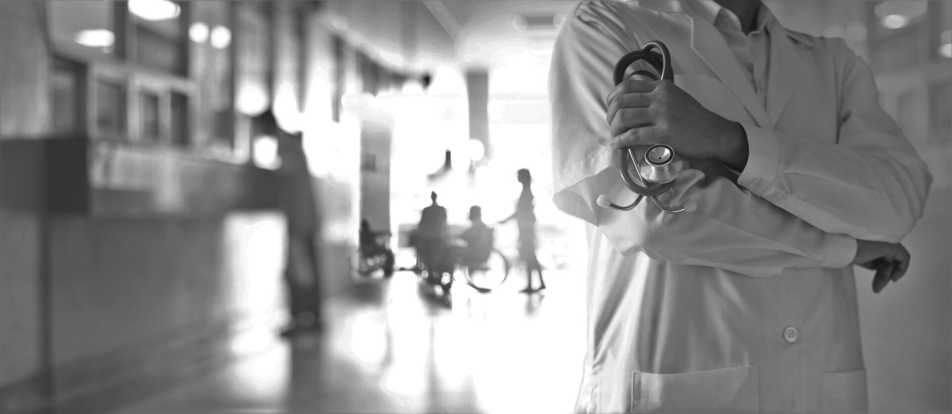 doctor with stethoscope in hospital hallway